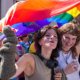 Photo de rue - La gay pride à lille, deux jeunes filles sous un drapeau